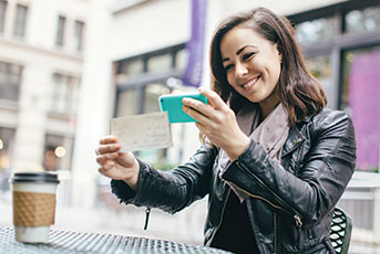 Woman taking a picture of a check with her smartphone